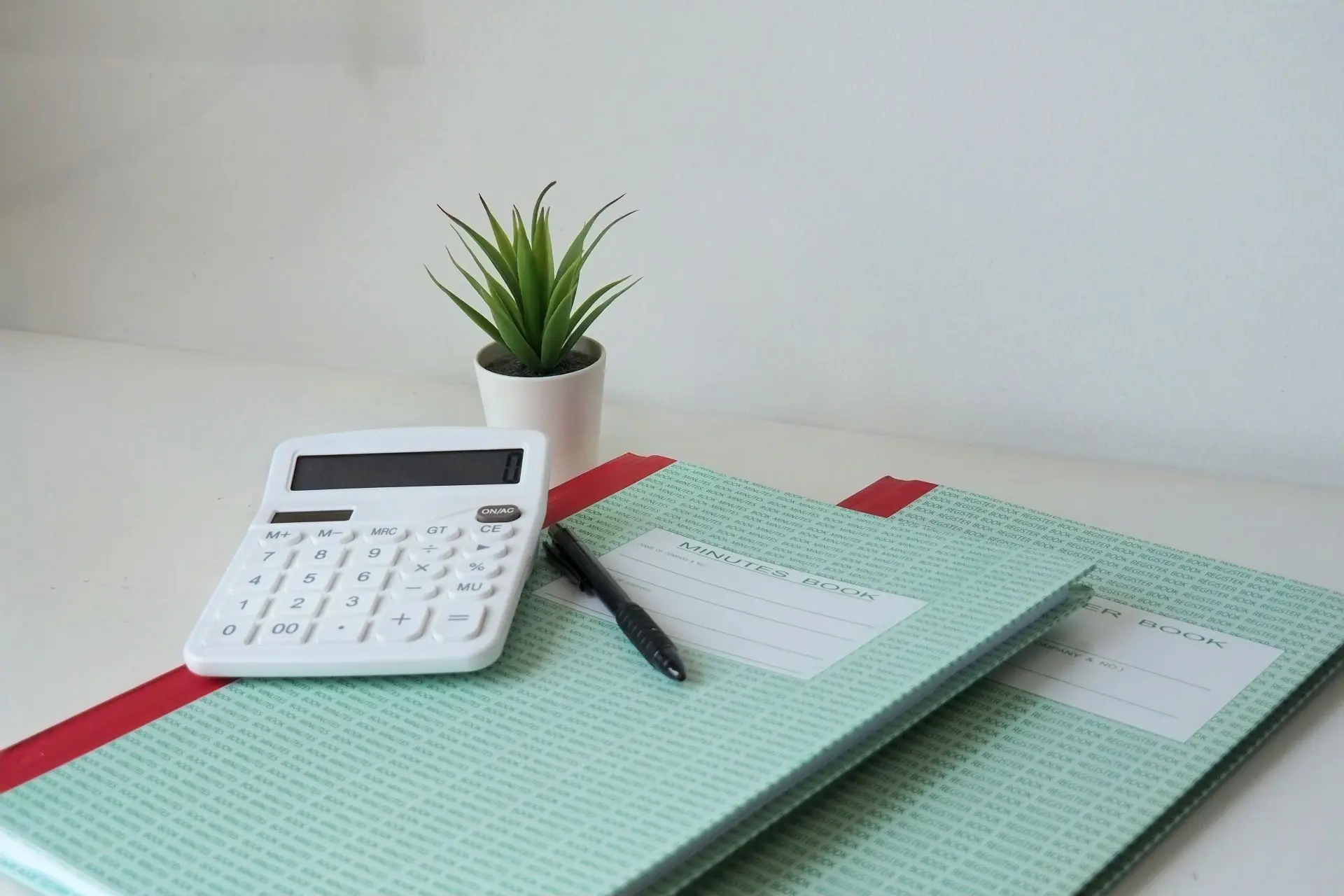 Minutes book and register book on a desk